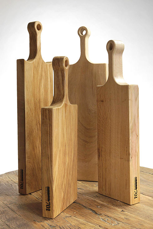 as selection of hand sculpted solid wood cheese or bread boards with long necks loop terminals and branded motifs