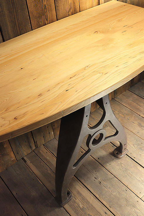 a sublime consort table with a gently bowed front edge solid timber top and timeworn cast iron machine-base support