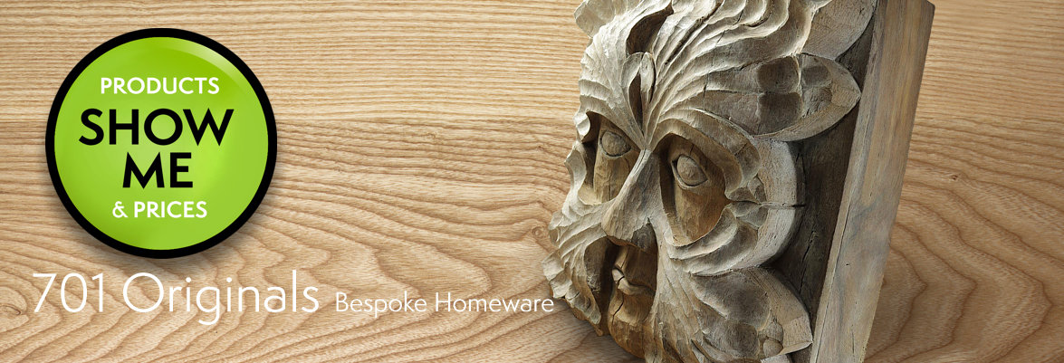 carved wood figure of a green man stood on a highly figured piece of beech wood