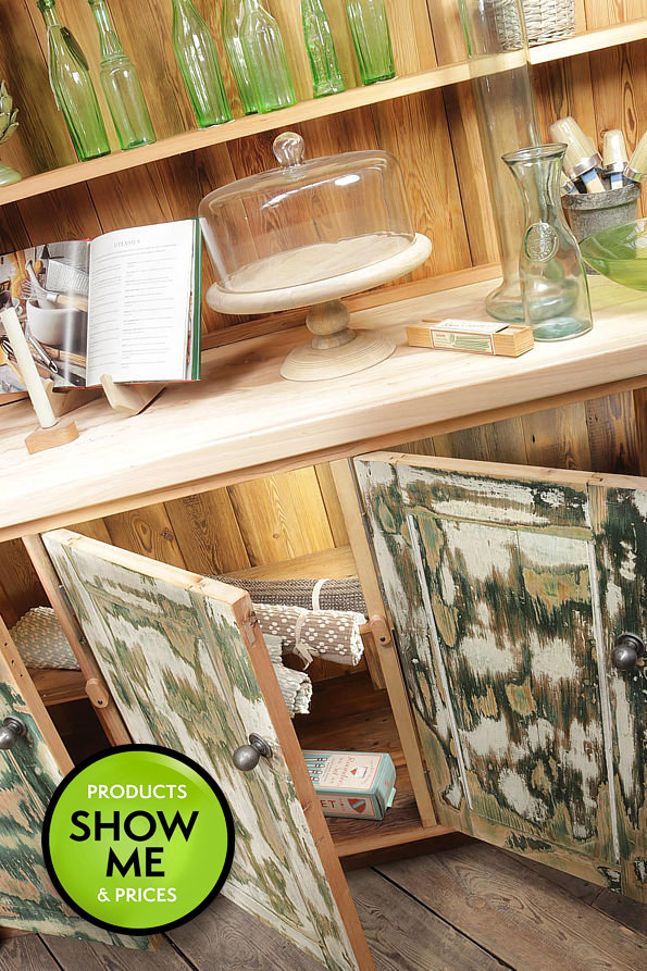 close up of a wholly reclaimed handmade beechwood and pine dresser with patch-paint doors filled with decorative kitchenware