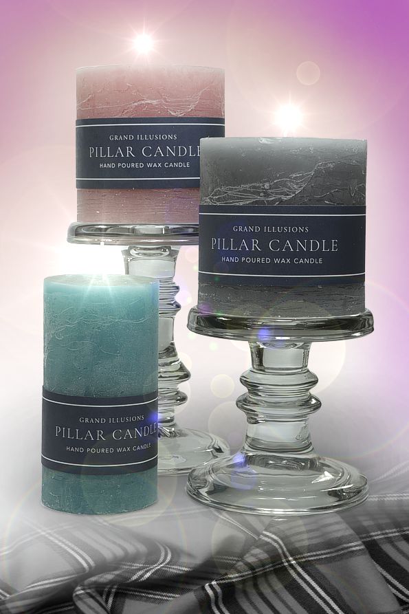 A cameo of three Grand Illusion pillar candles in pink, charcoal and aqua