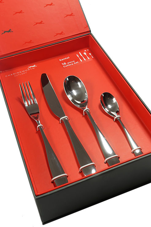 A red display box containing a 16 piece Charingworth cutlery set in the finest stainless steel