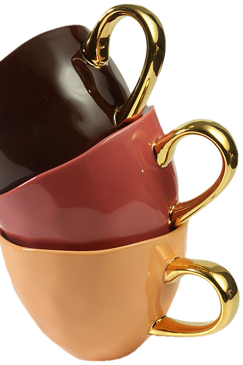 Close-up of three coffee cups in chcolate brown, terracotta and caramel with gilded handles