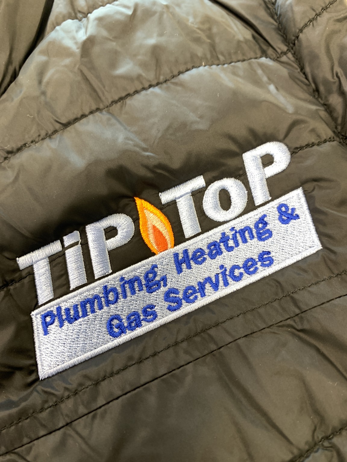Logo Embroidery on a workwear jacket for Tip Top Plumbing, Heating & Gas Services