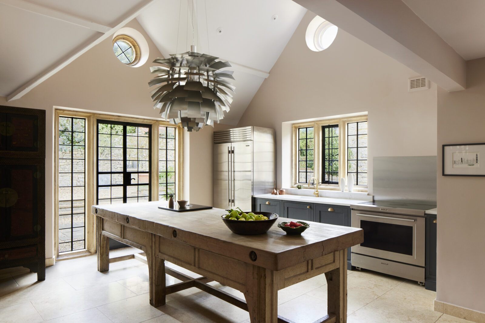 Tumbled limestone floor in a vaulted kitchen