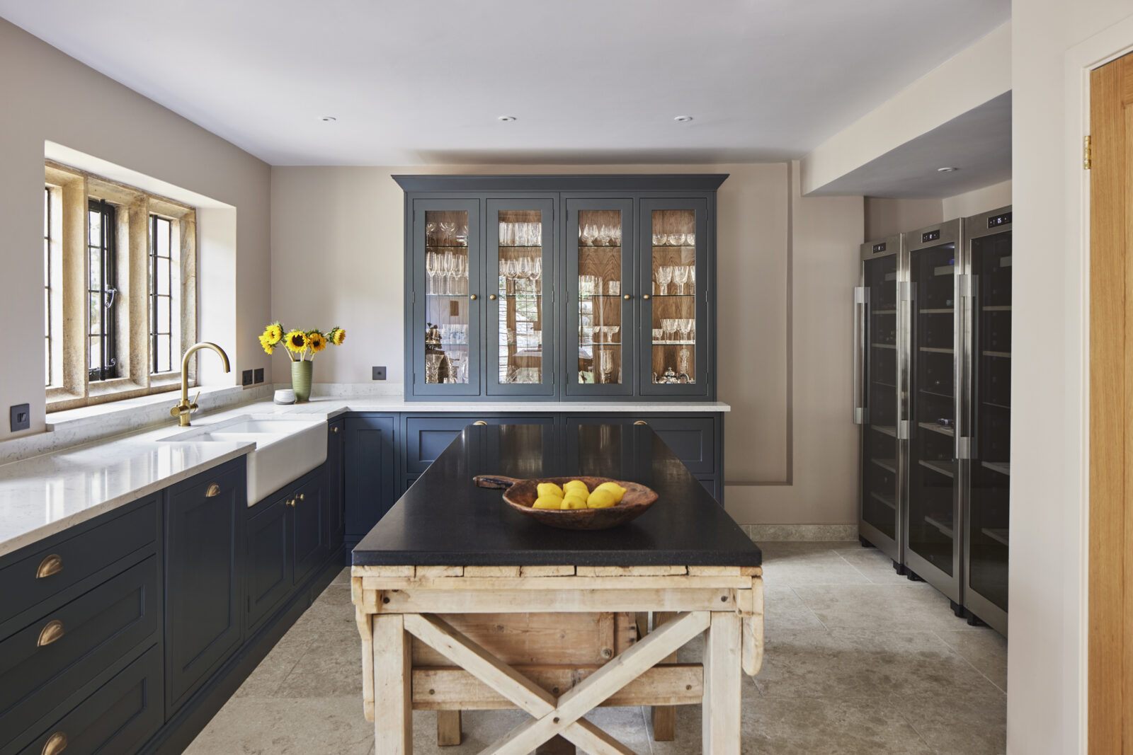 Egyptian limestone floor in a navy shaker kitchen
