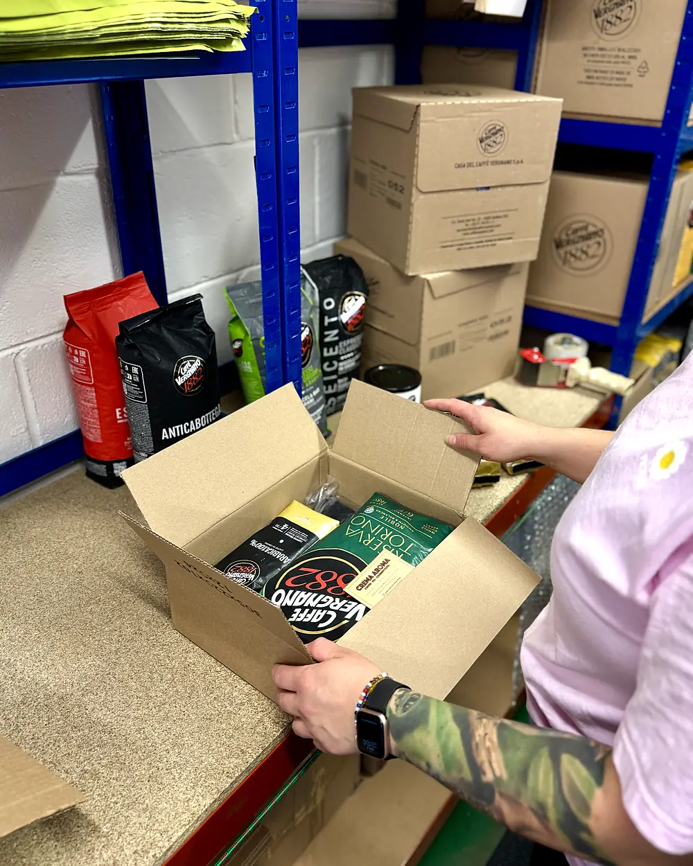 Packing a Caff&egrave; Vergnano order at the Crema Aroma bench in Livingston: Riserva Torino and Arabica beans going into the carton
