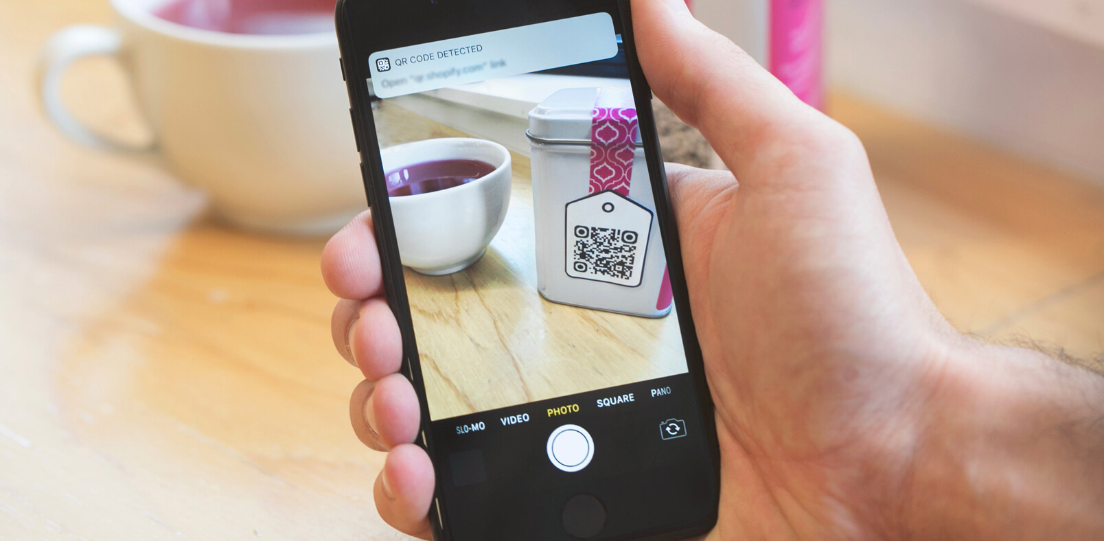 a mobile phone scanning a qr code on an ecommerce product