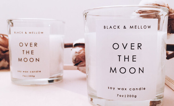 two soy wax candles with over the moon branding